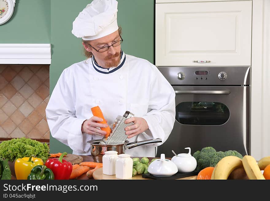 Young chef preparing lunch in kitchen