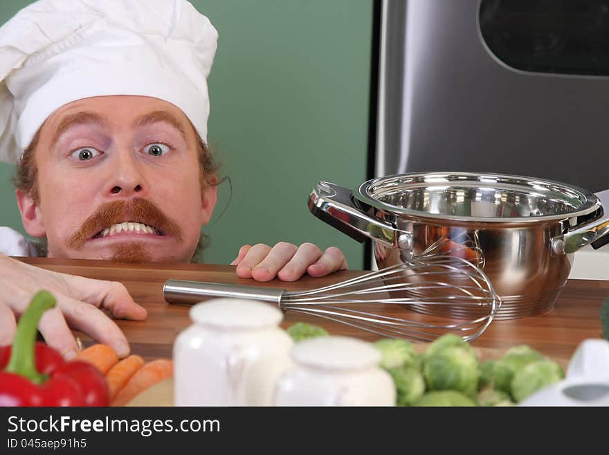 Funny young chef with a pot