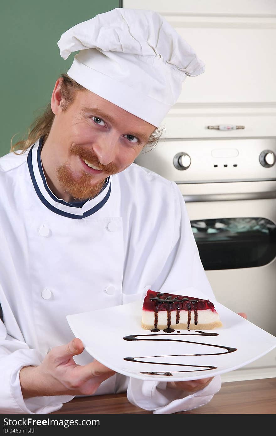 Young chef with piece of cake with chocolate sauce