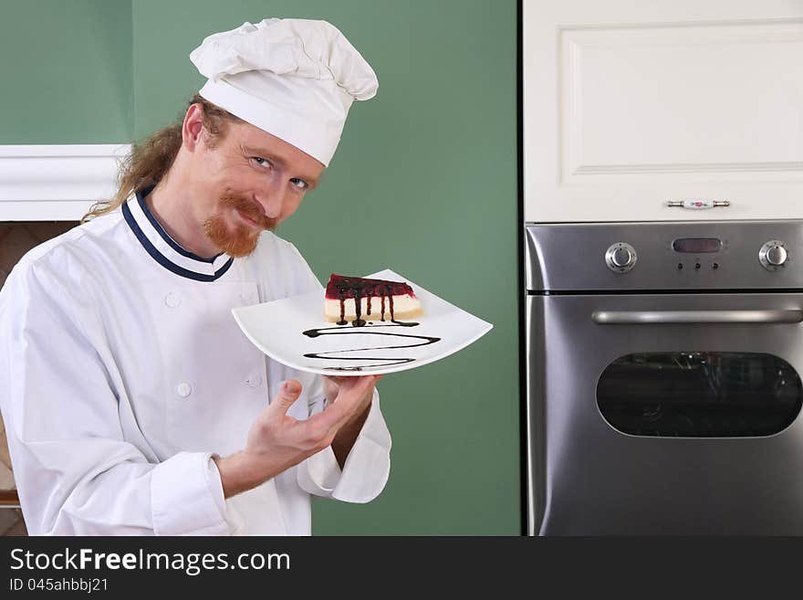 Young chef with piece of cake