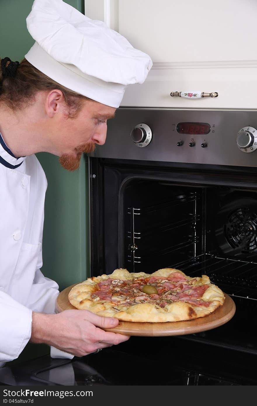 Young chef prepared italian pizza in kitchen. Young chef prepared italian pizza in kitchen