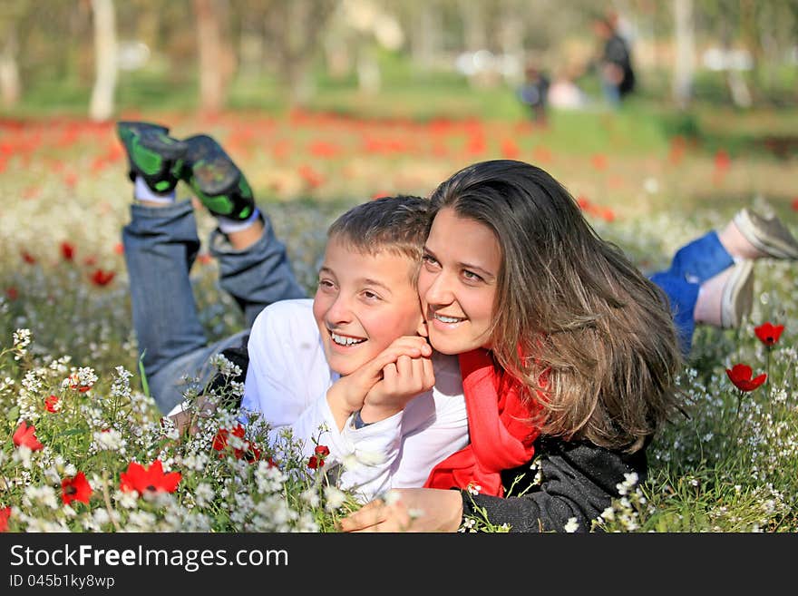 Family mother and son playing on the lawn. Family mother and son playing on the lawn