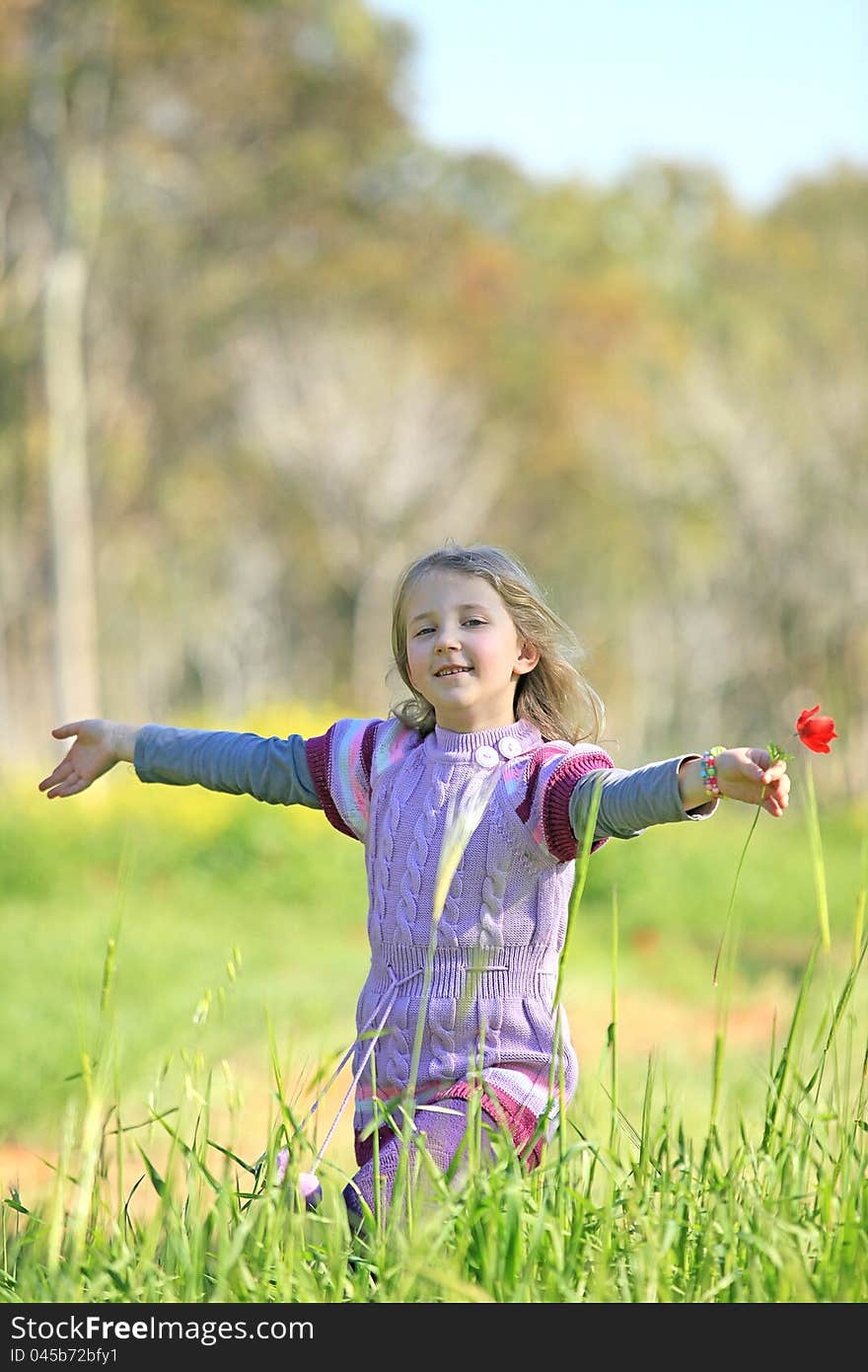 Portrait of a girl running  the grass