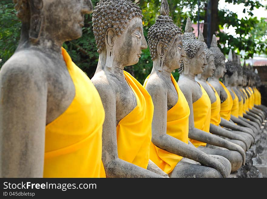 Row of Ruin images of Buddha in Ayutthaya historical park, Thailand