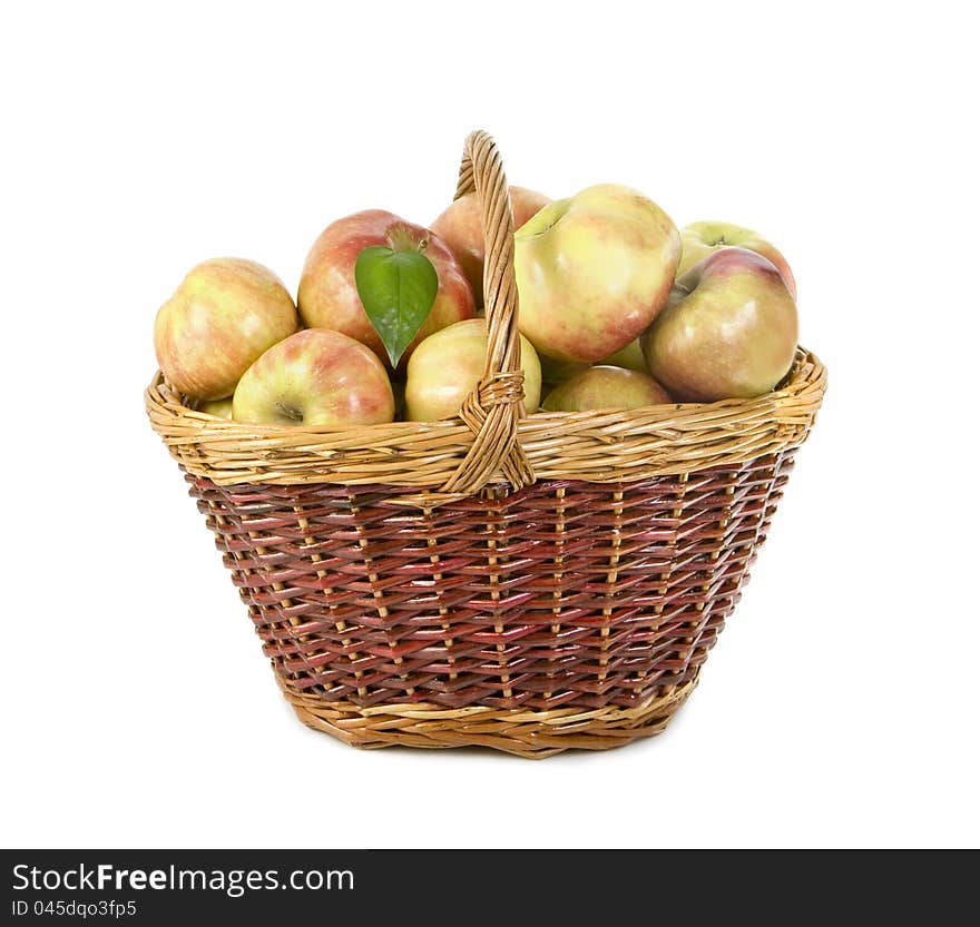 Apples lie in a basket on a white background