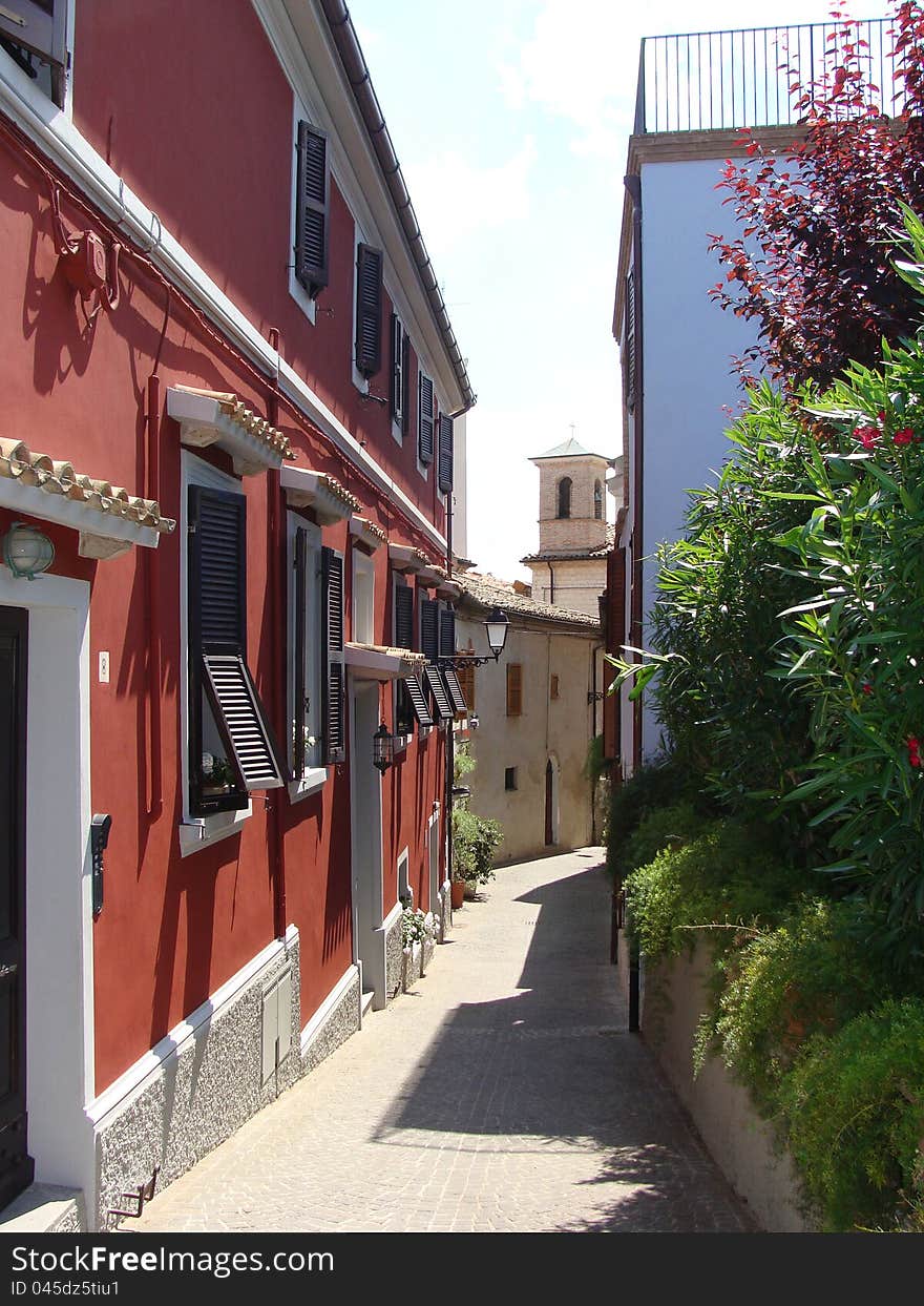 Narrow European street with the red house Italy. Narrow European street with the red house Italy