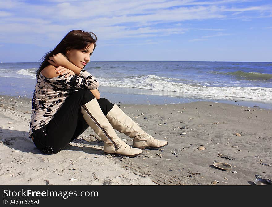 Sexy Girl Sitting On The Beach