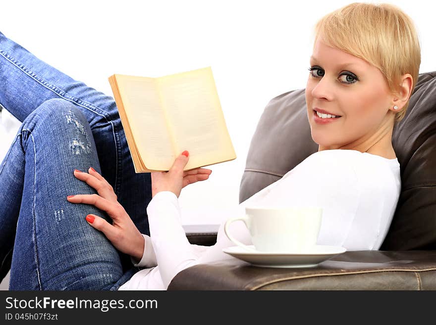 A young woman reading a book in a library