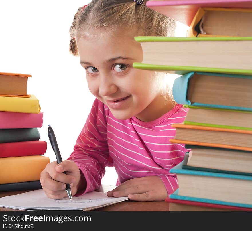 Blonde happy schoolgirl works on her homework, write something in her notepad, isolated on white