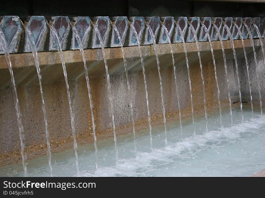 Multi-stream fountiain pouring into a pool. Multi-stream fountiain pouring into a pool