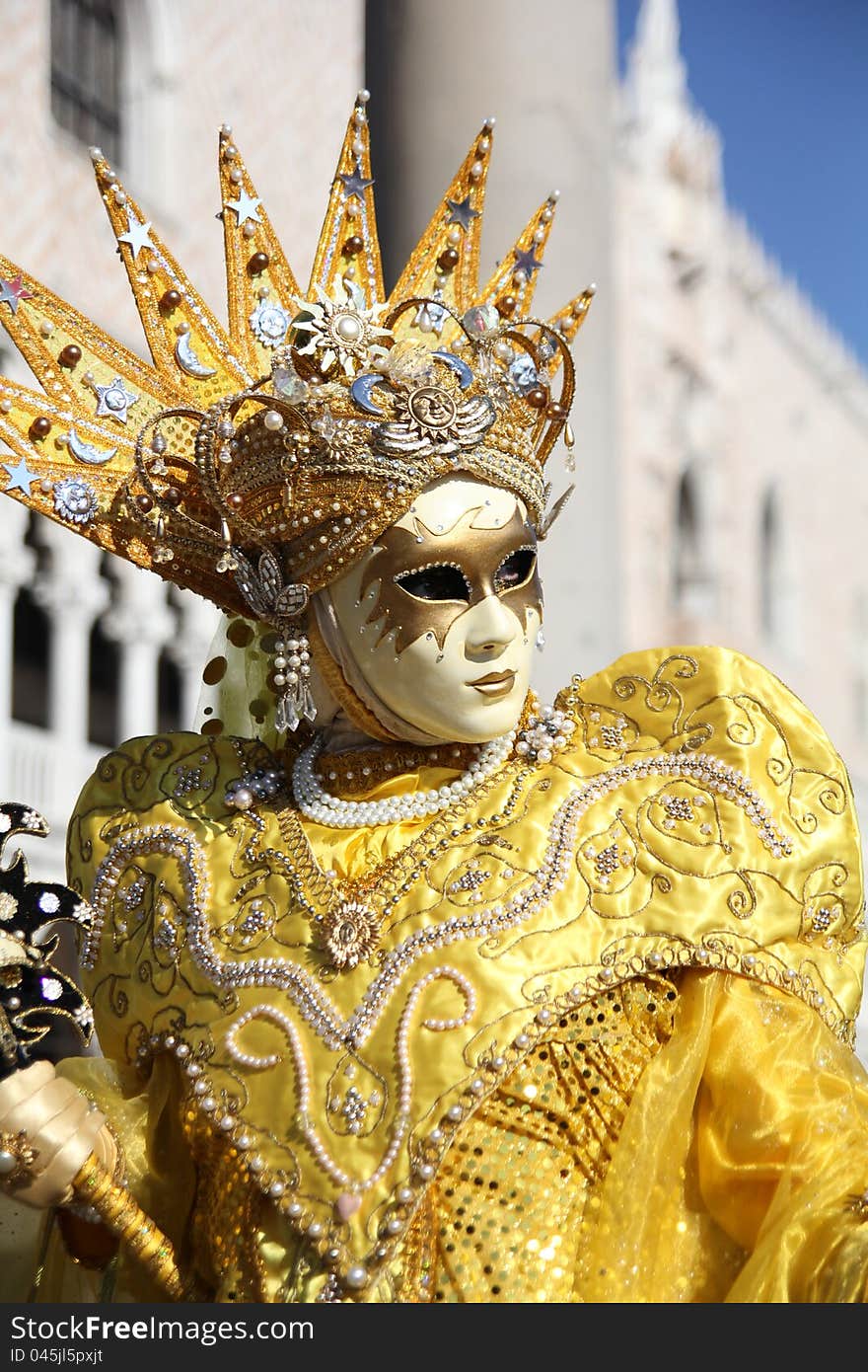 A yellow carnival mask in VEnice, Italy.