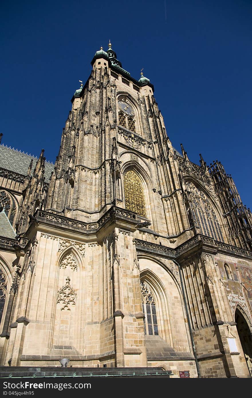 Dominant at the Prague Castle, view from the bottom of the cathedral of St. Vitus Cathedral on a sunny day, St. Vitus Cathedral with blue sky, the old Prague monument