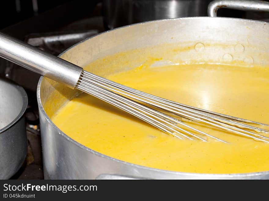 Cooking a vegetable soup in a kitchen fire