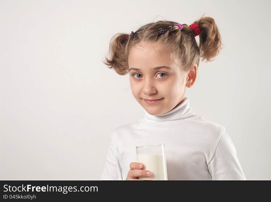 Cute little girl drinks milk