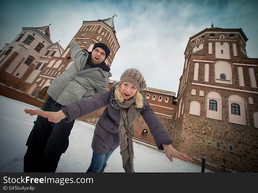 Traveling couple in love at the walls of the ancient castle