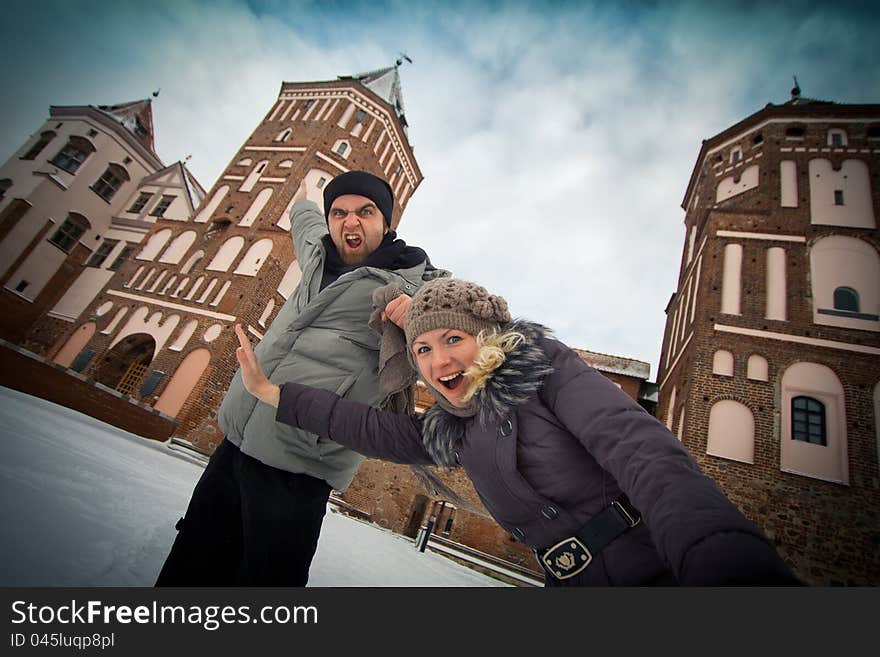 Traveling couple in love at the walls of the ancient castle