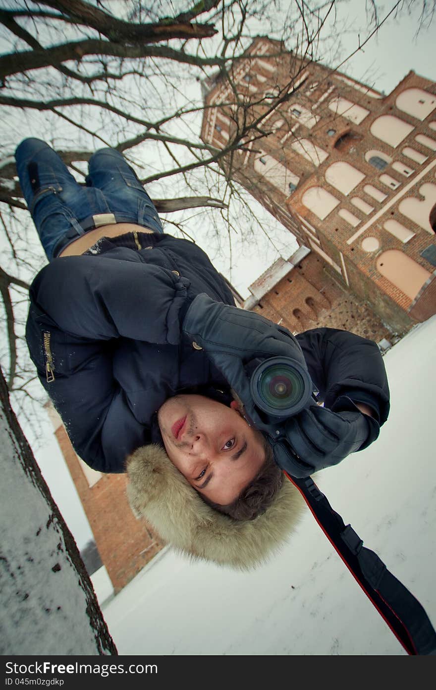 Photographer, hanging from a tree upside down