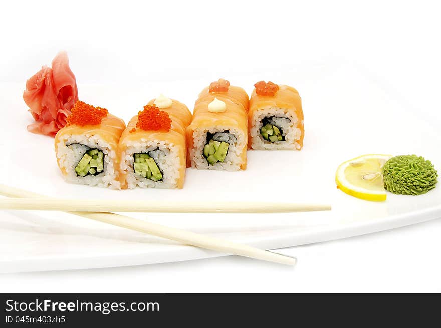 Sushi on a plate with chopsticks in a restaurant