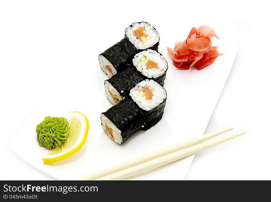 Sushi on a plate with chopsticks on a white background