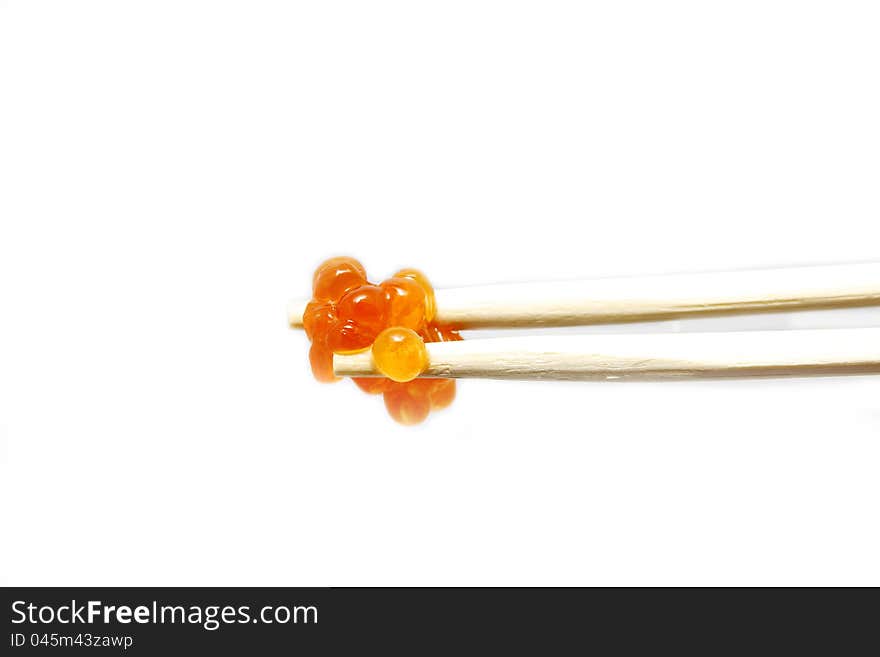 Eggs on the chopsticks on a white background. Eggs on the chopsticks on a white background