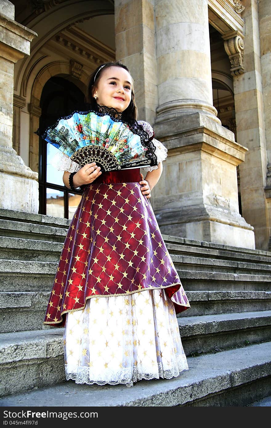 Girl dressed in vintage dress with fan in hand. Girl dressed in vintage dress with fan in hand