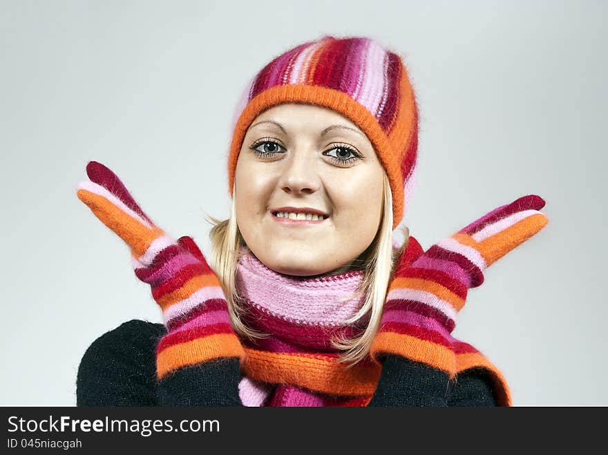 Beautiful girl in a hat and gloves on the background