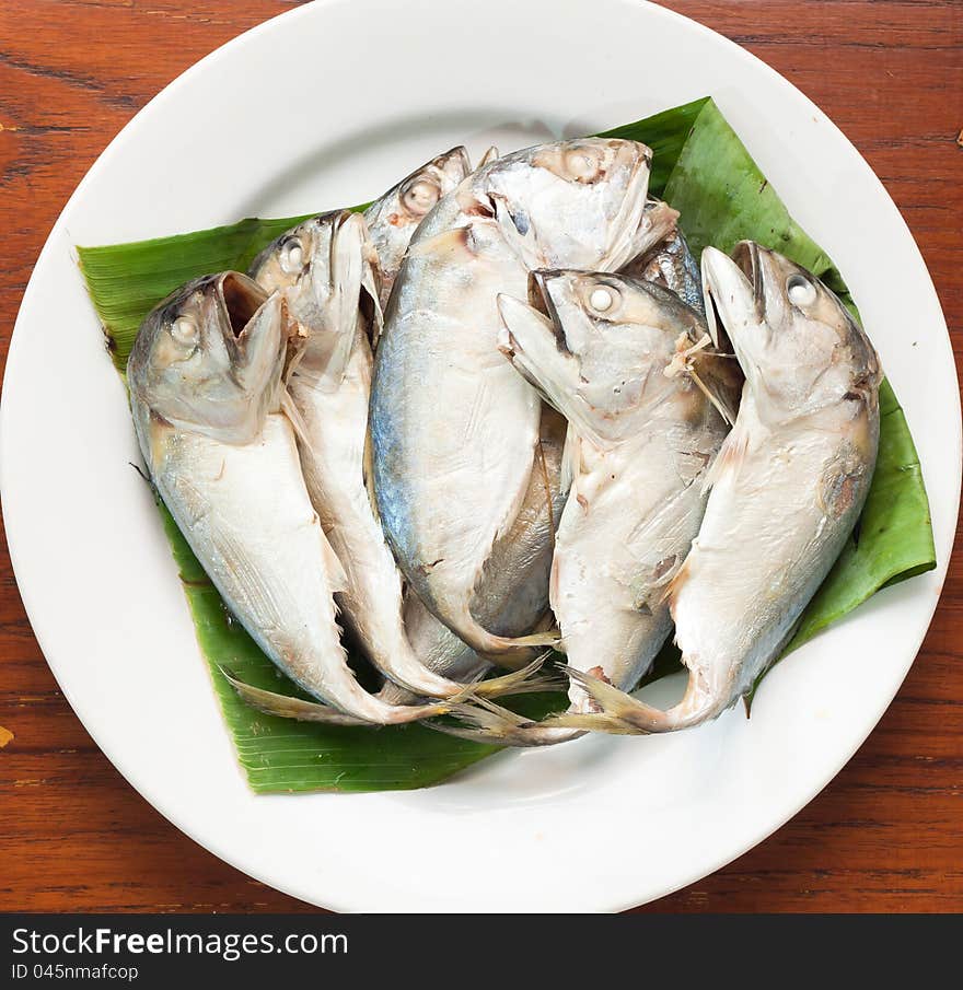 Boiled mackerel on green banana leaf