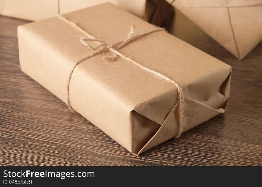 Pile parcel wrapped with brown kraft paper and tied with twine. Pile parcel wrapped with brown kraft paper and tied with twine