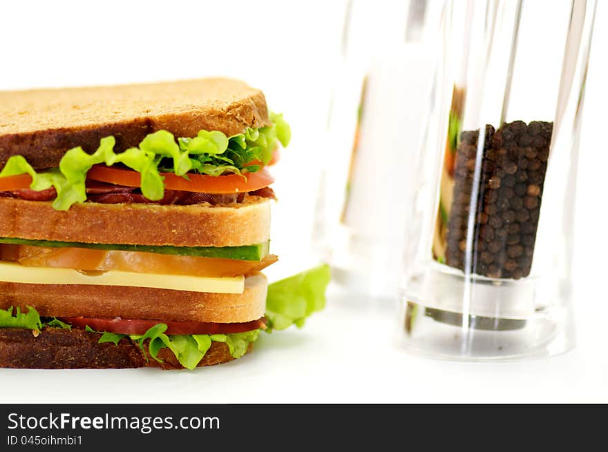 Classical BLT Club Sandwich with Saltcellar and pepperbox isolated on white background