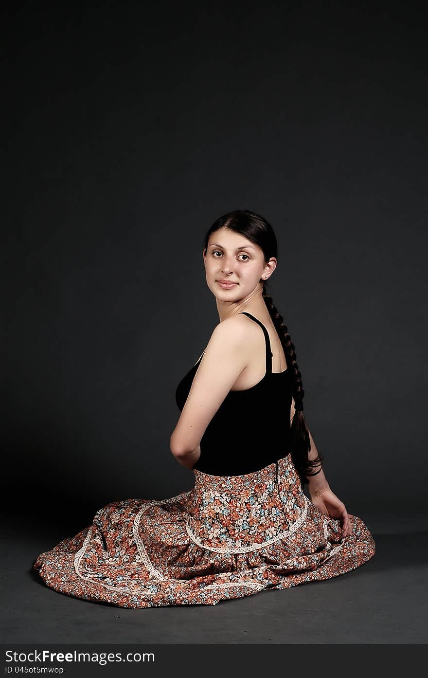 Girl with skirt posing in a studio