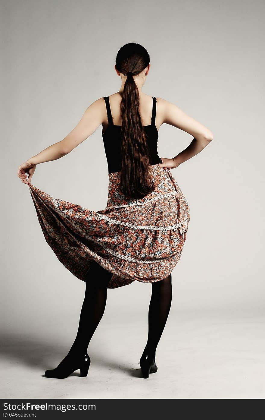 Girl with skirt posing in a studio