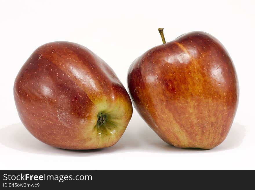 Two ripe red apples in the foreground. Isolated on a white background