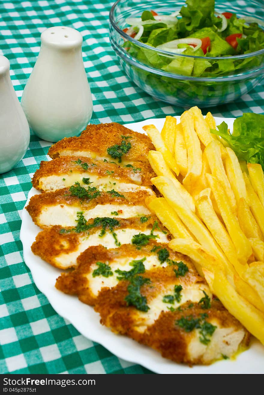 French fries and chicken white meat with fresh salad