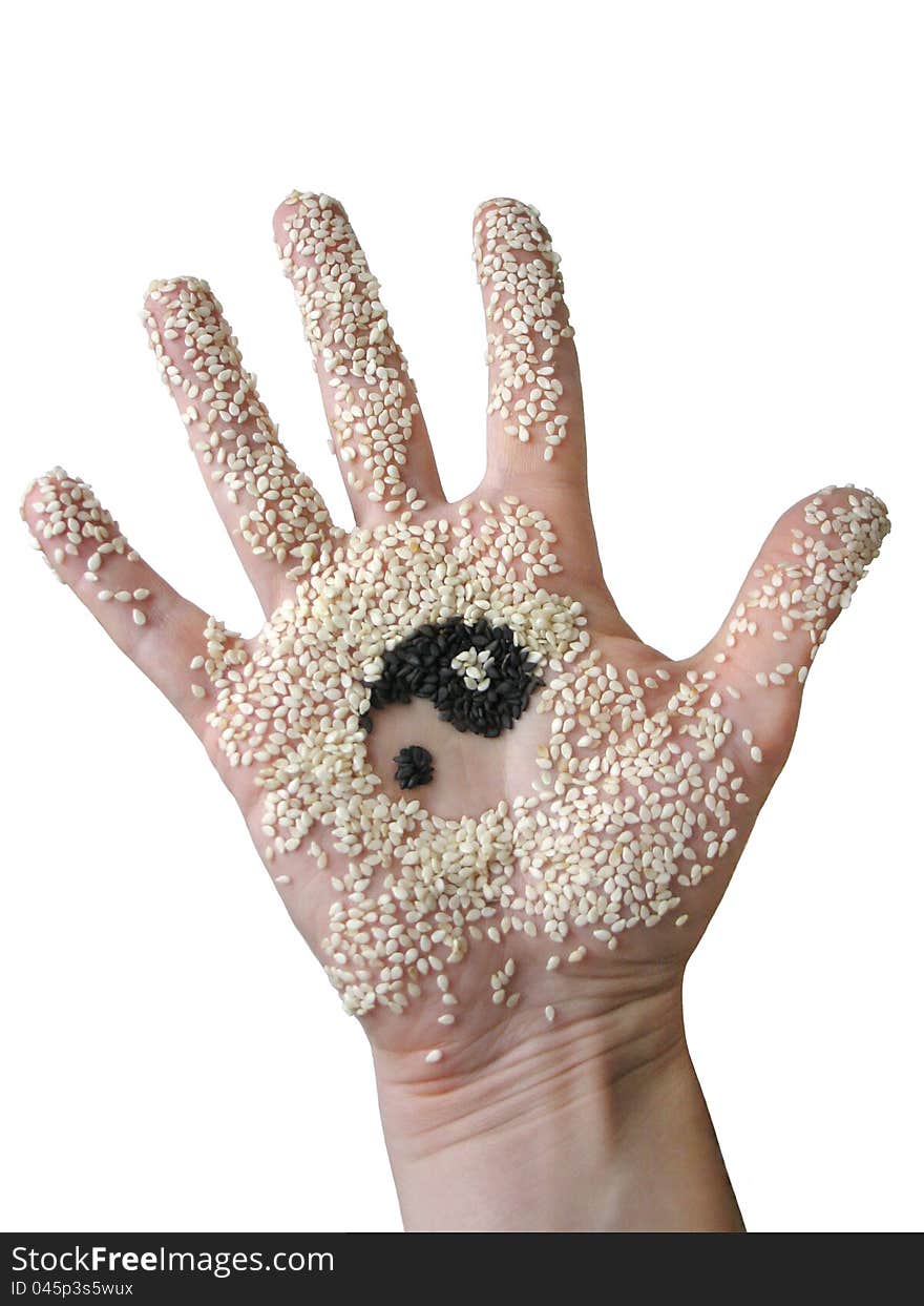 Hand with sesame seeds and adhering pattern yin yang. Hand with sesame seeds and adhering pattern yin yang