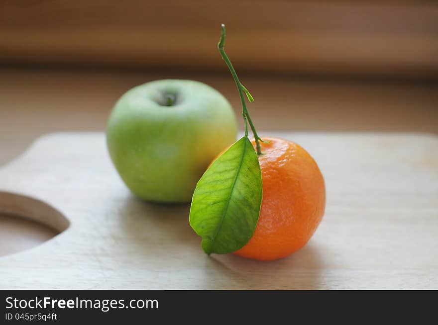 Fresh moroccan tangerine (mandarin) and green apple. Fresh moroccan tangerine (mandarin) and green apple