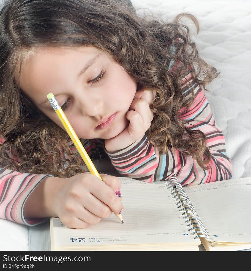 Little Girl With Notebook And Pen