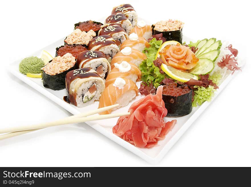 Large plate of sushi and cucumber salad decoration