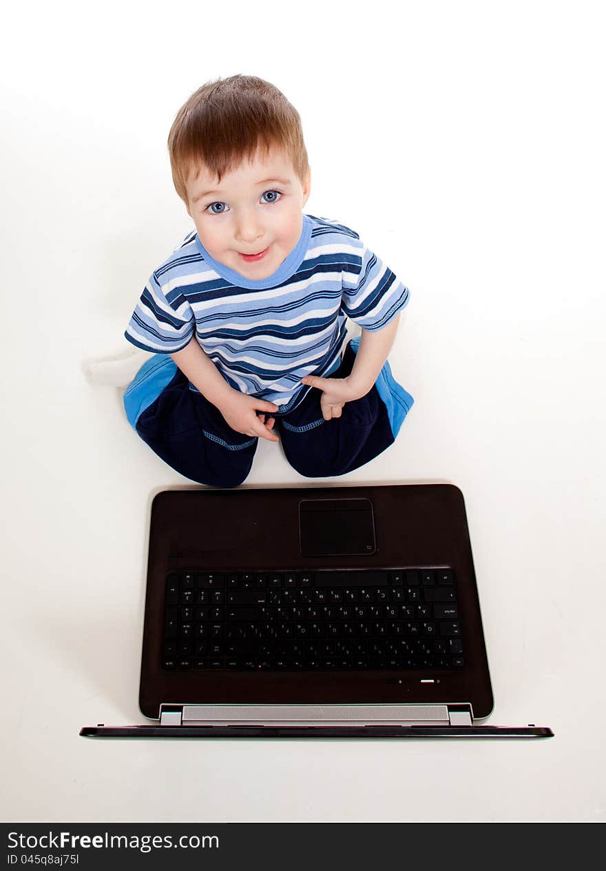 Child using a laptop over white background. Child using a laptop over white background