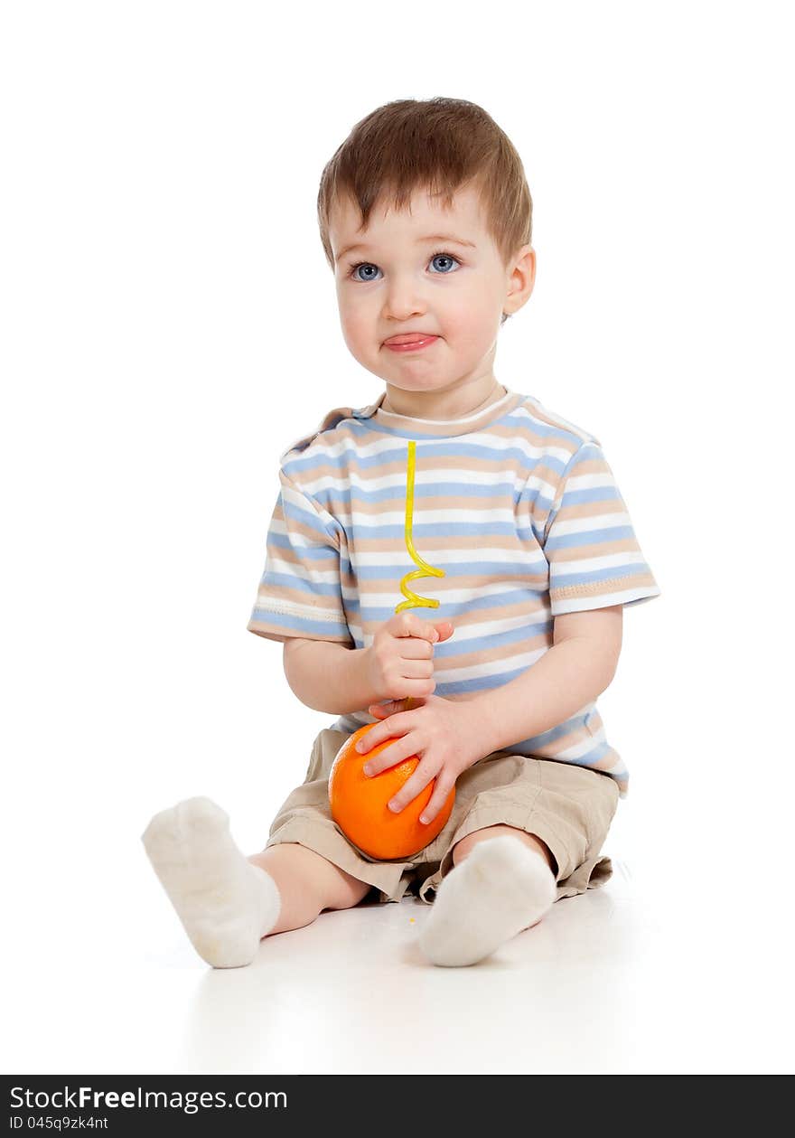 Funny child drinking orange through straw over white background. Funny child drinking orange through straw over white background