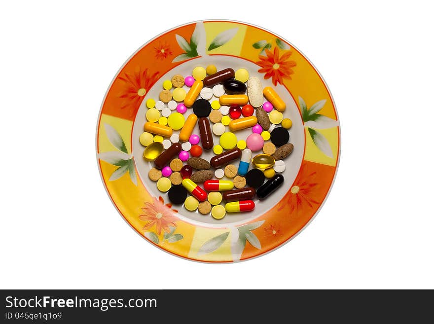 A lot of tablets in a dish isolated on a white background.