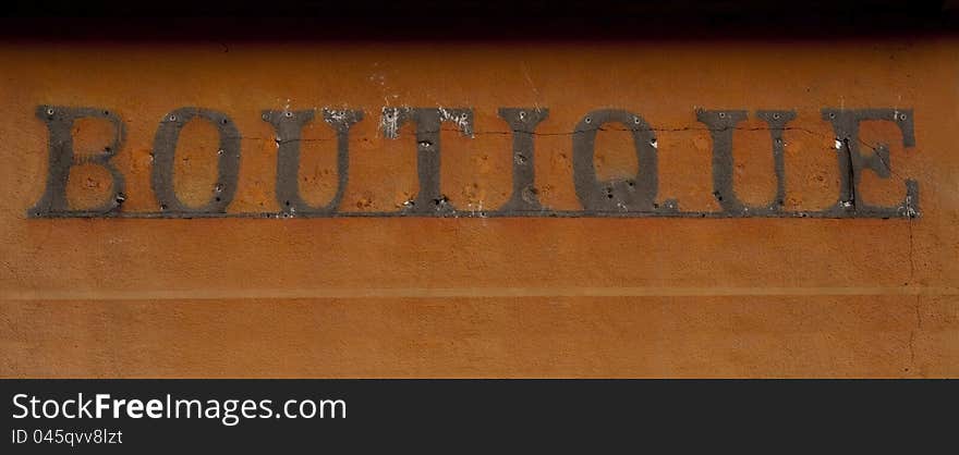 Remains of an old advertisment on the orange wall after letters (business) removal, Metaphoric - bancruptcy. Remains of an old advertisment on the orange wall after letters (business) removal, Metaphoric - bancruptcy