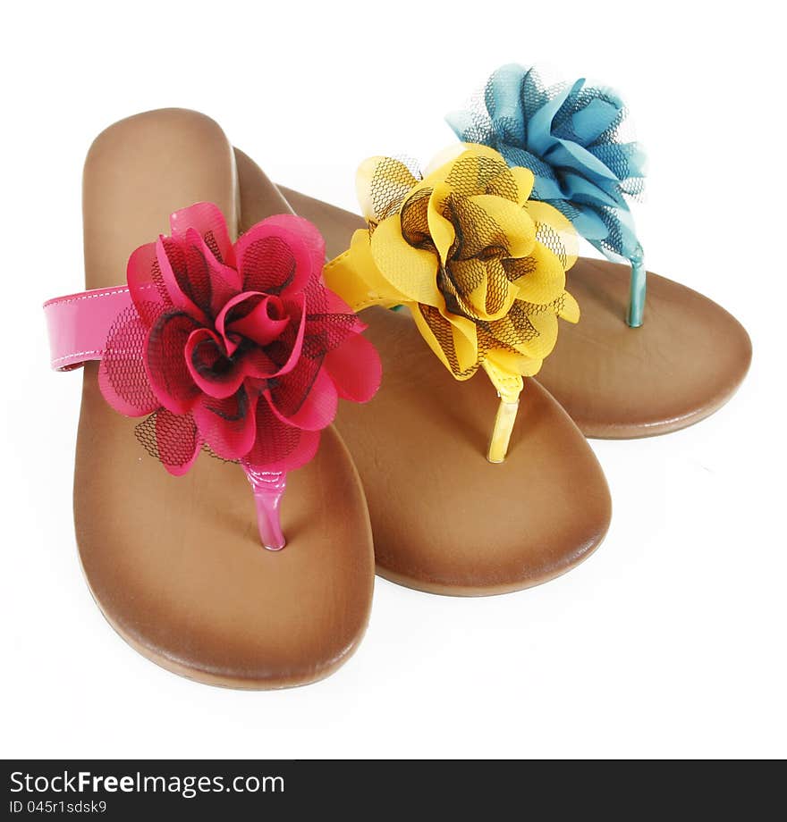 Colored flip-flops with flowers isolated on white