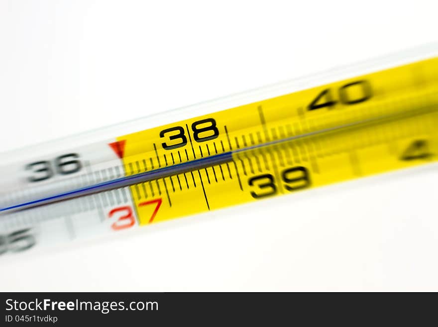 Close-up shot of a medical thermometer showing 38.5 with radial blur