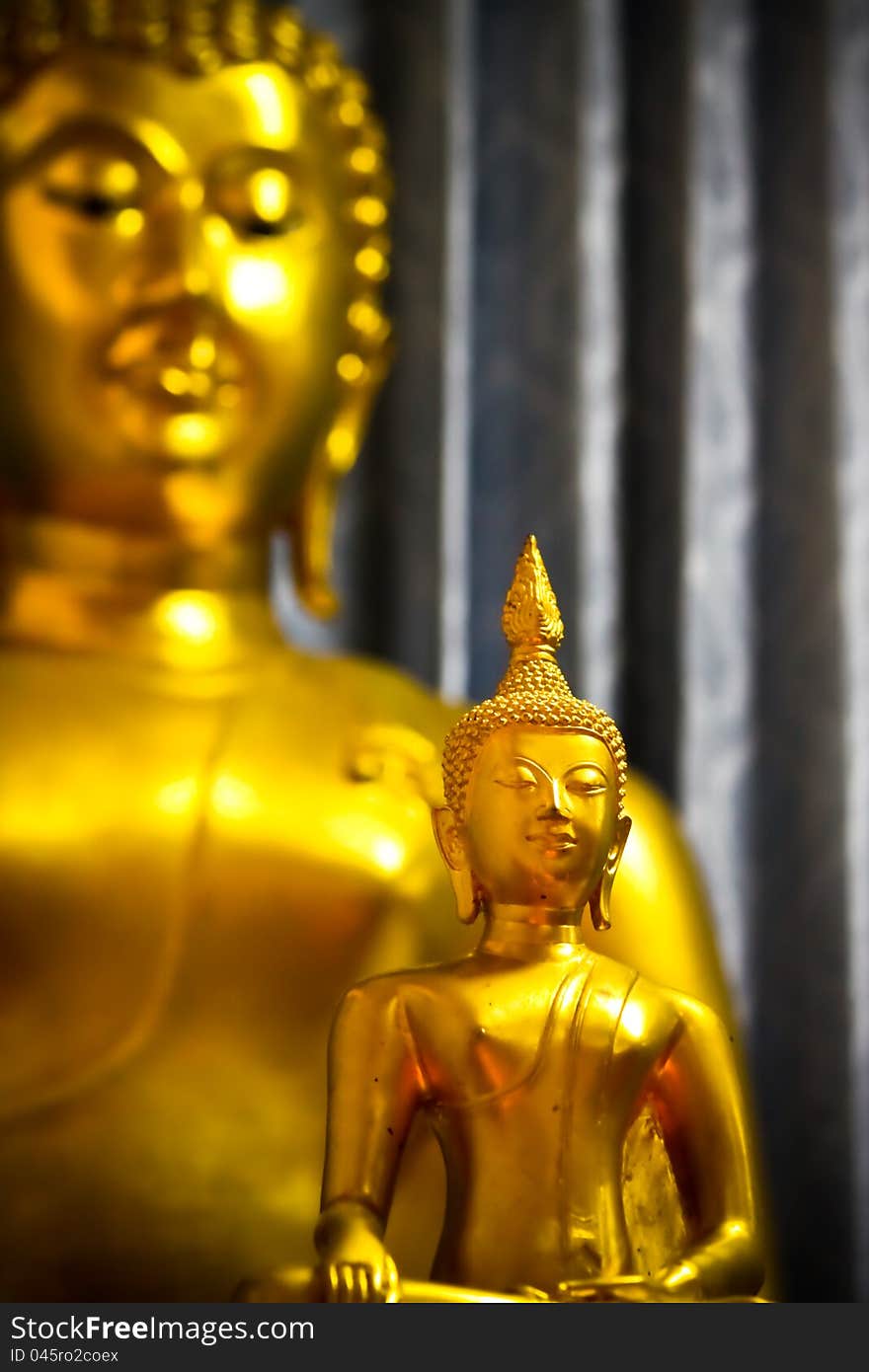 A big and small golden buddha. A big and small golden buddha