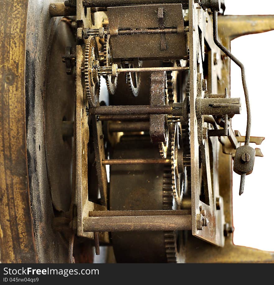 Mechanism of the old wall clock, the yellow metal, dust, cobwebs