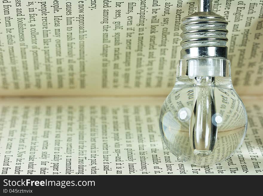 Photo of a light bulb on old book