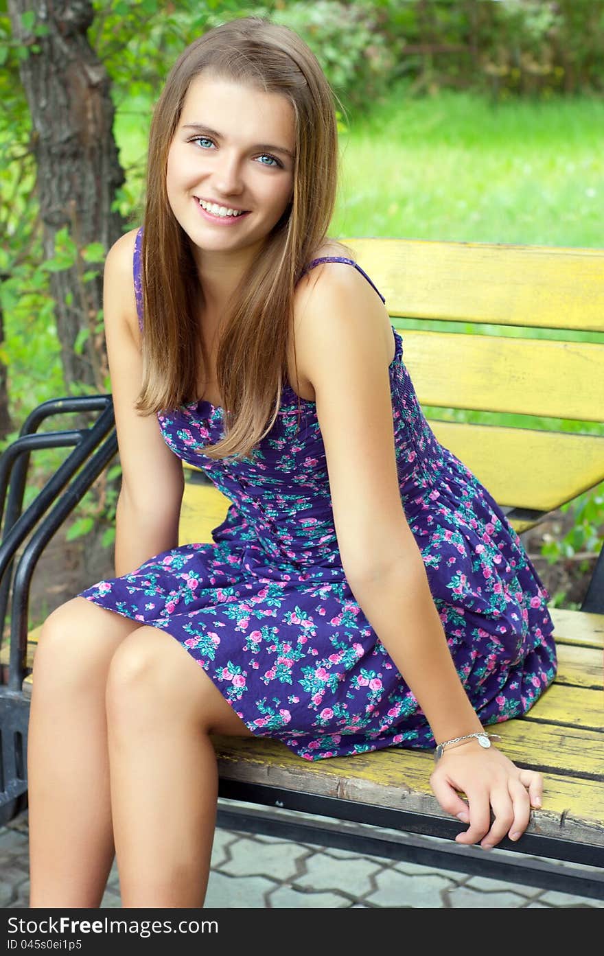 Beautiful girl sitting on a bench