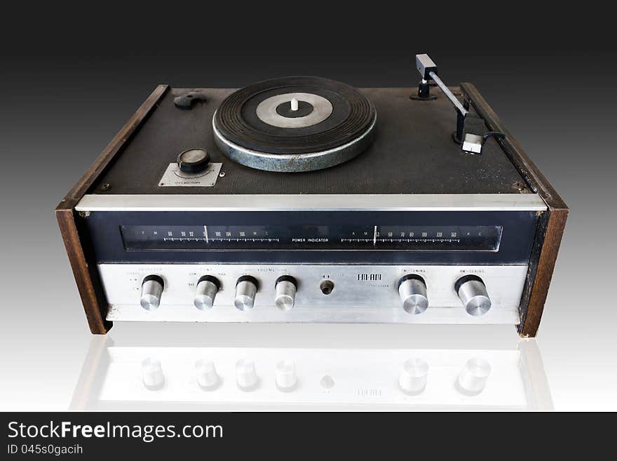 Vintage record player with radio tuner isolated on black background