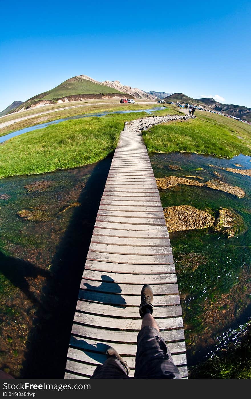 Walking the wooden boardwalk in the mountains, POV -feet visible. Walking the wooden boardwalk in the mountains, POV -feet visible