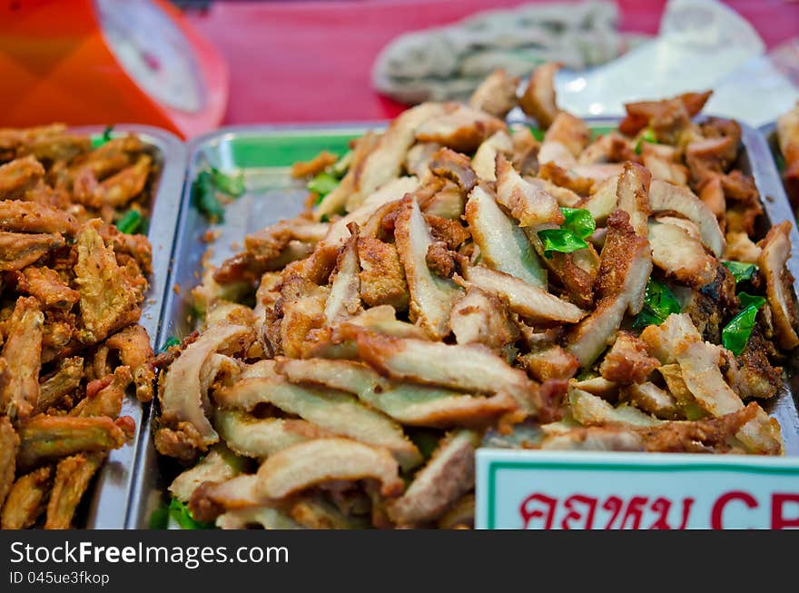 Fried pork's neck on the market of Thailand. Crispy, juicy, and yummy. Fried pork's neck on the market of Thailand. Crispy, juicy, and yummy.